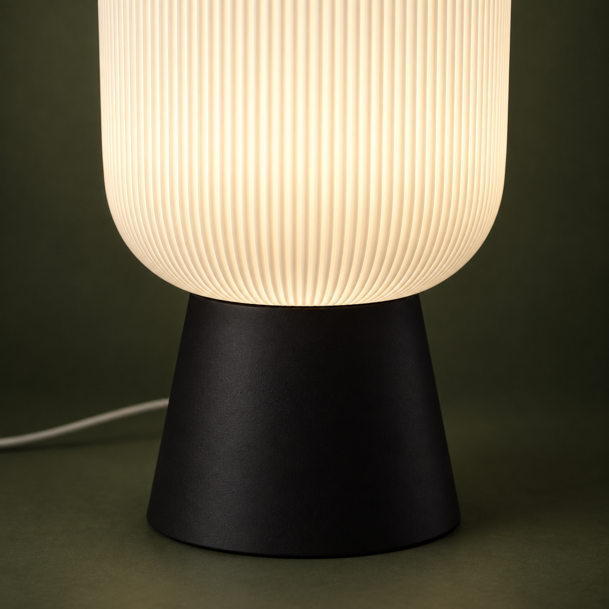 Close-up of the ZENITH ribbed diffuser and matte black tapered base