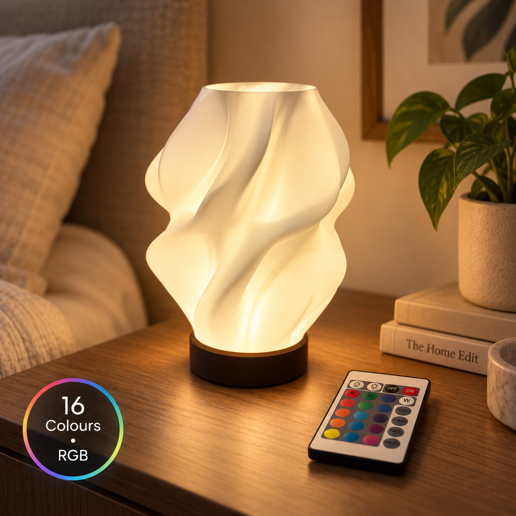 NEBULA RGB sculptural table lamp in a warm bedside setting with remote control