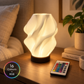 NEBULA RGB sculptural table lamp in a warm bedside setting with remote control