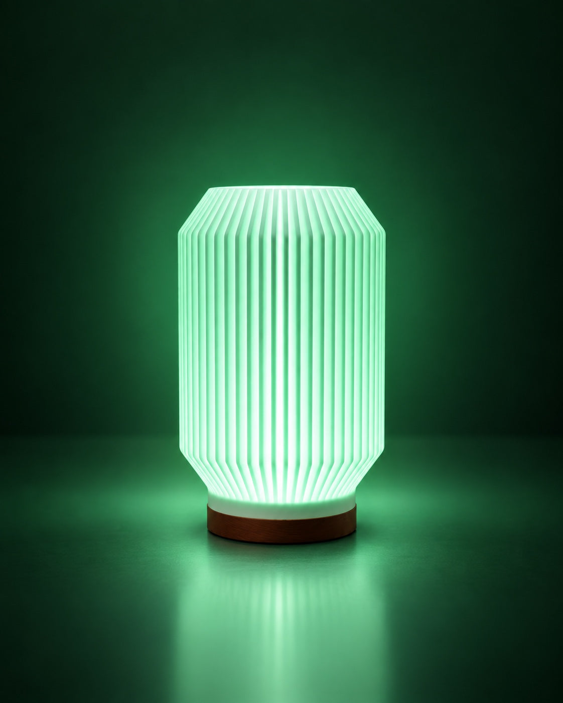 HALCYON RGB lamp glowing green on a dark green studio background