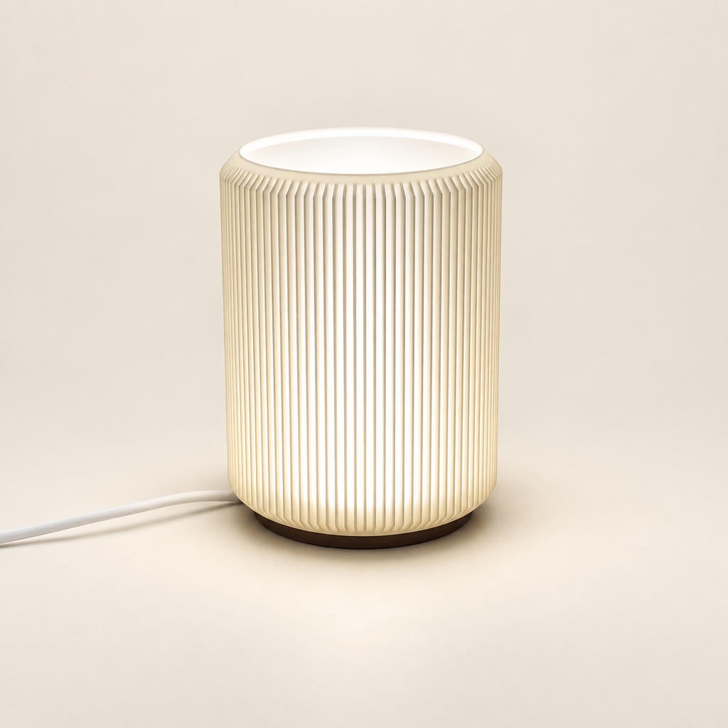 NIMI mini table lamp showing its ribbed shade and dark base on a cream background