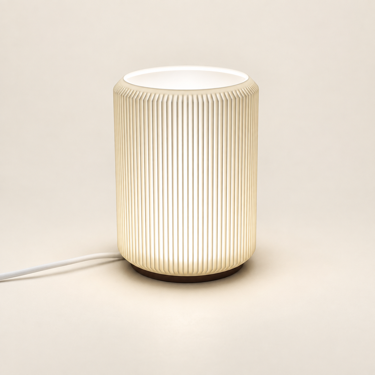 NIMI mini table lamp showing its ribbed shade and dark base on a cream background