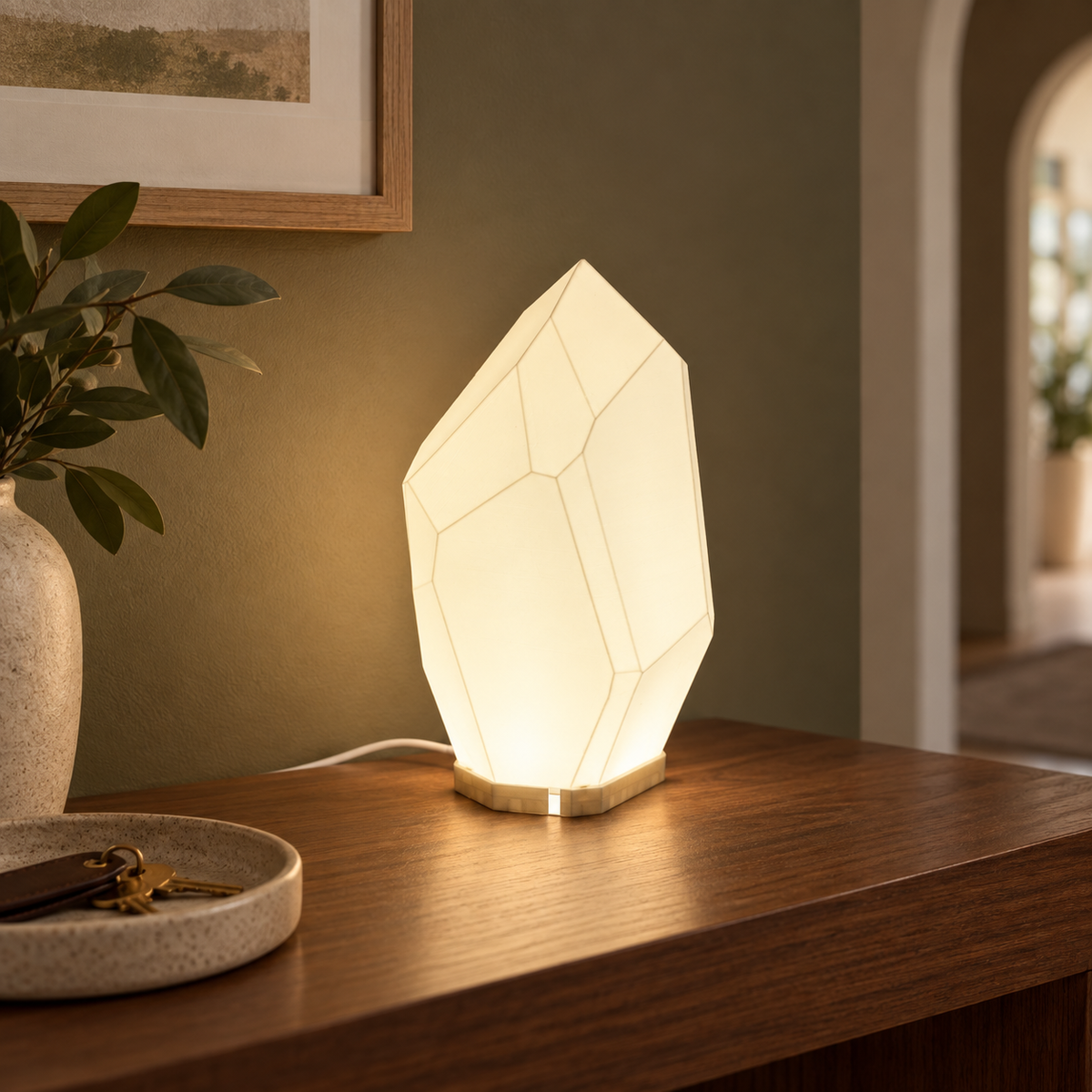 FACET geometric table lamp styled on a hallway console with soft warm light