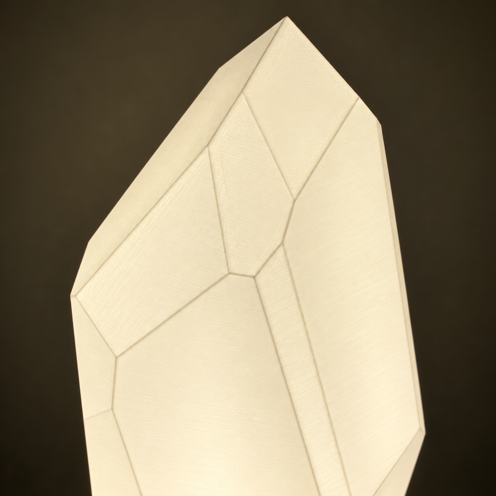 Close-up of the FACET lamp's pointed silhouette and geometric shade