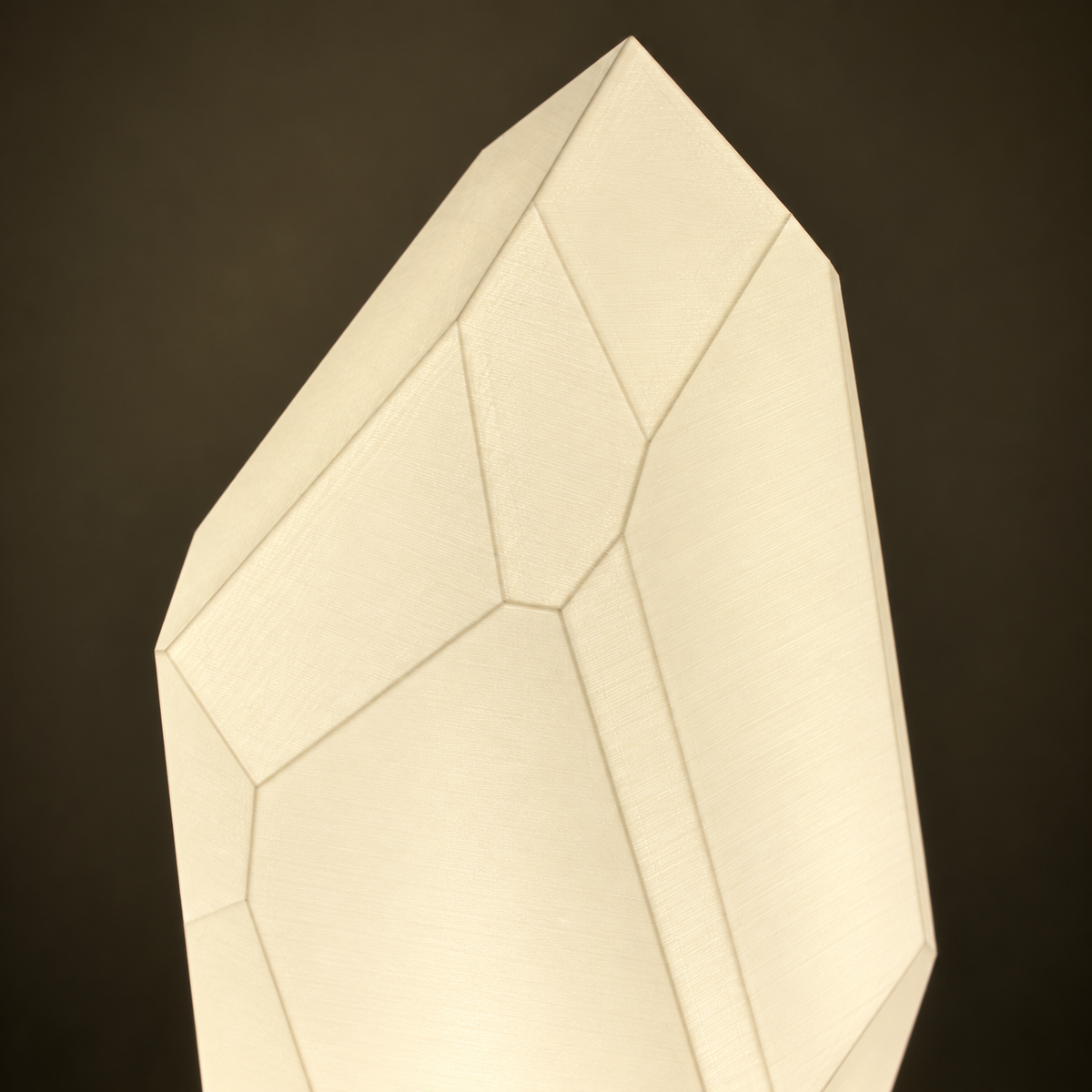 Close-up of the FACET lamp's pointed silhouette and geometric shade