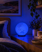 ORBIS RGB globe lamp glowing blue in a modern Australian coastal bedroom